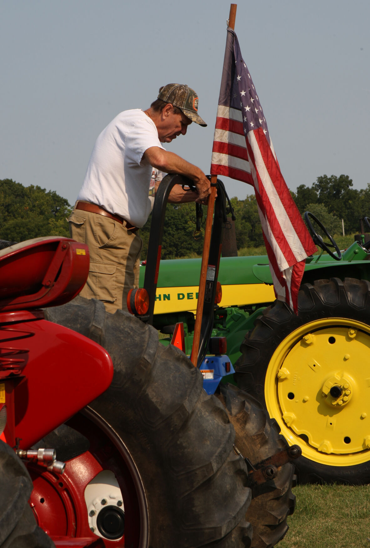 George Miller attaches a flag to his tractor